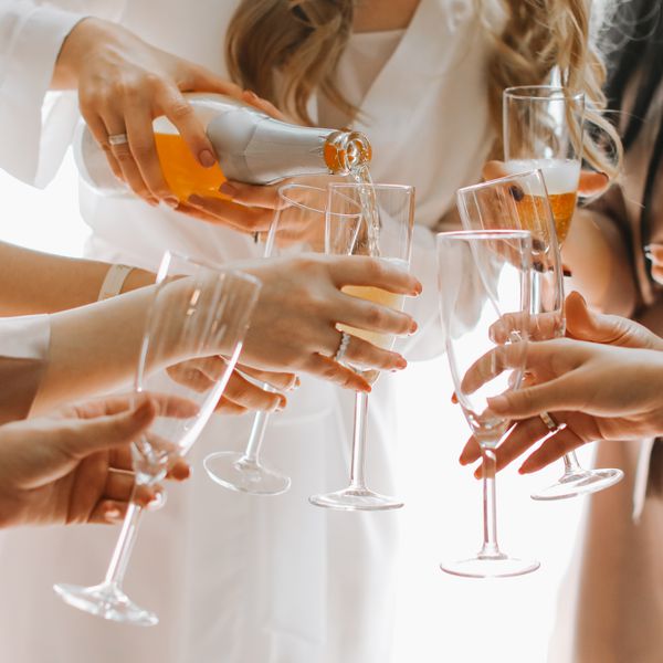 bride and bridesmaids pouring champagne