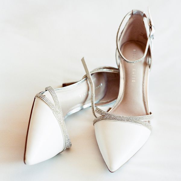 still shot of white wedding shoes with crystal embellishments
