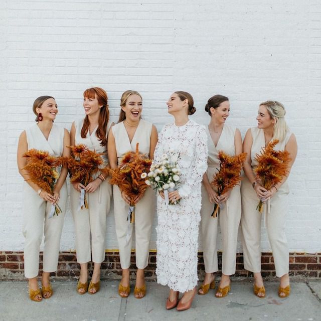Bridesmaids and bride holding bouquets of fall flowers