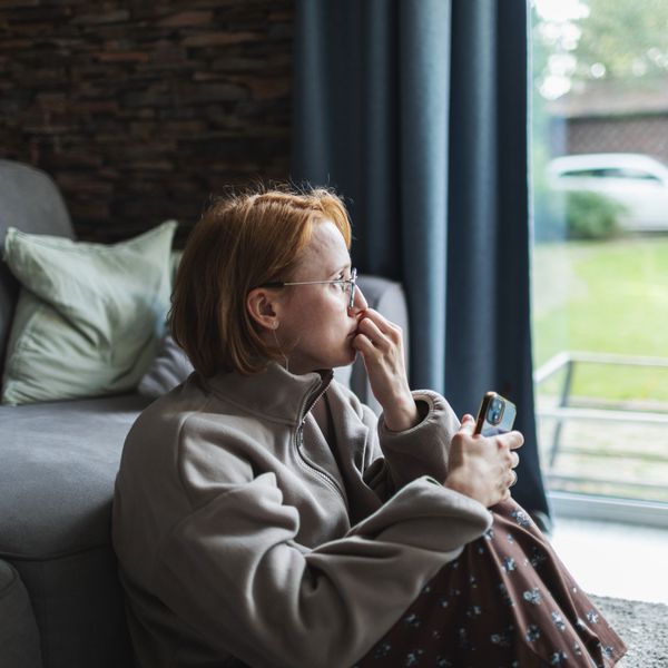Woman Looks Out the Window as She Contemplates an Emotionally Abusive Relationship