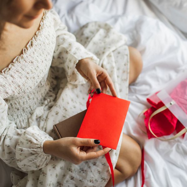 Woman Opens an Envelope, Wondering How Much You Should Spend on a Bridal Shower Gift