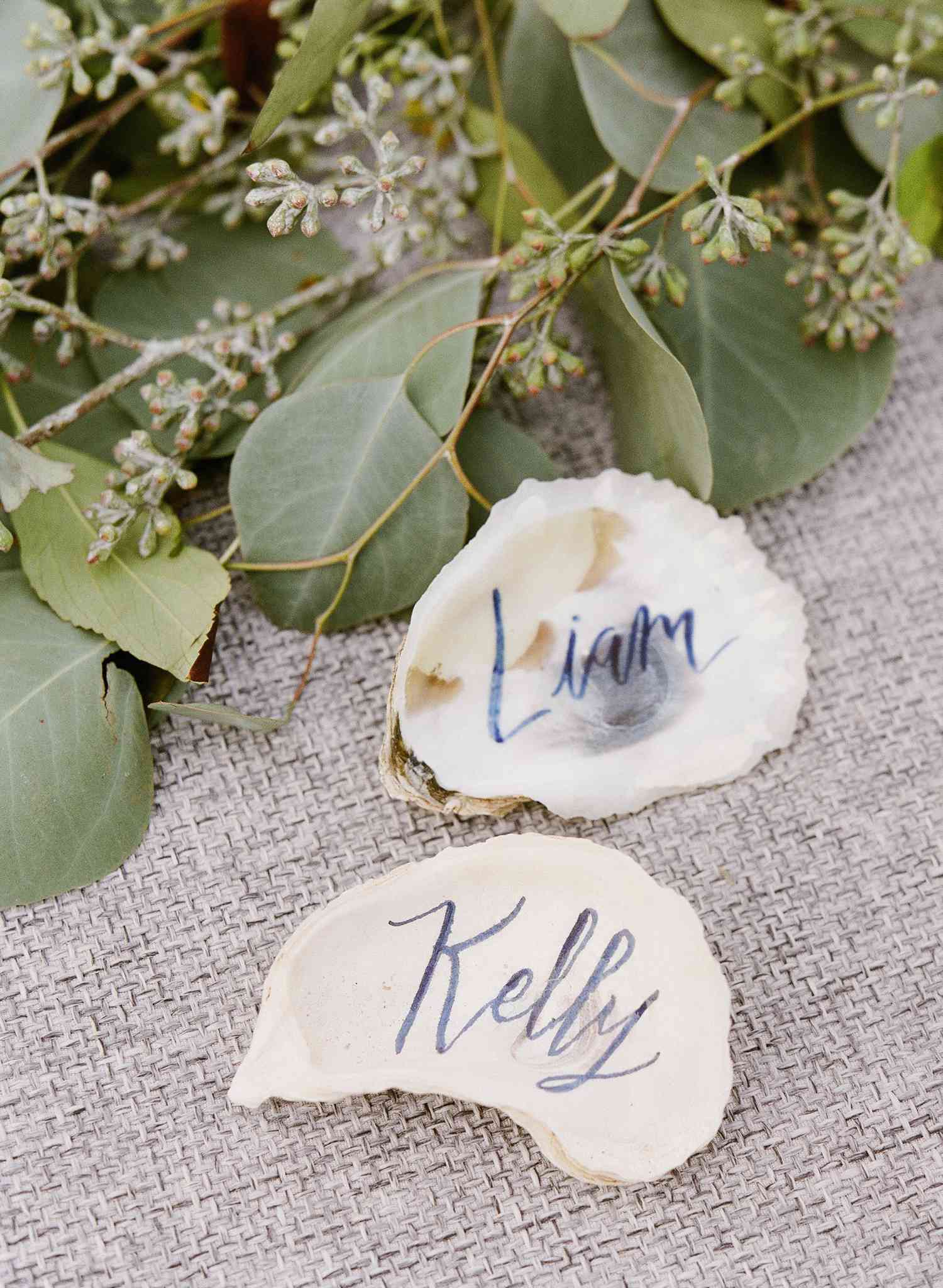 Oyster shells with calligraphy as wedding place cards