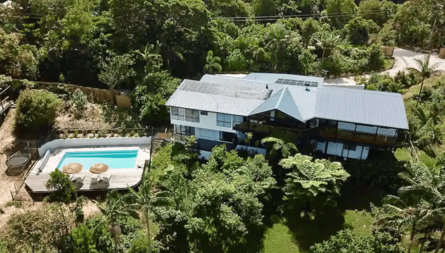Home Next to an Outdoor Pool and Surrounded by Trees