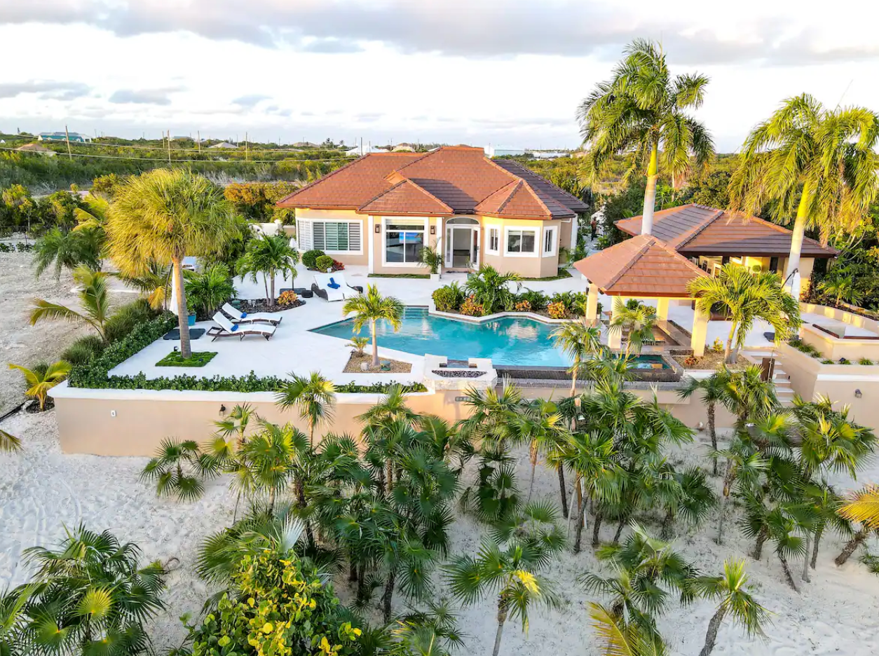 Beachfront Estate With Pool Surrounded by Palm Trees