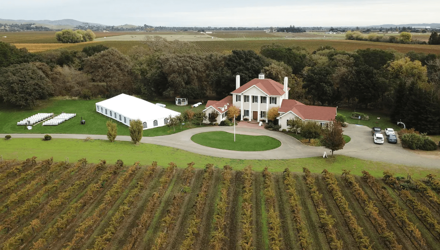 Estate on Vineyards With Trees and Water in the Background
