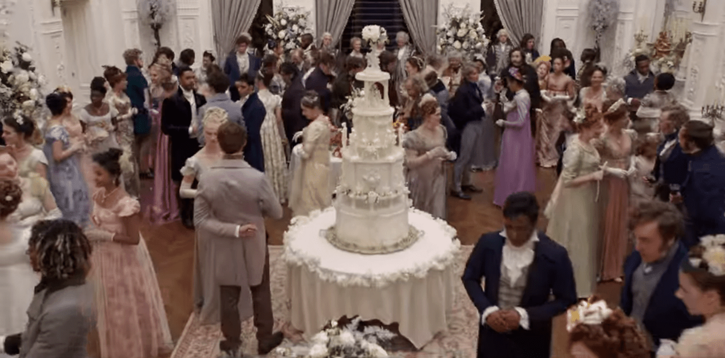 A 4.5-foot-tall wedding cake centerpiece in a crowded room